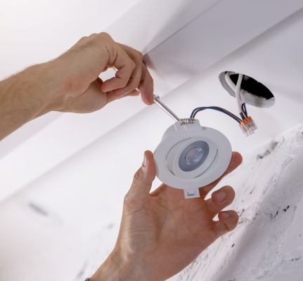 image of a ceiling spot light being installed by a skilled fit & fix tradesman