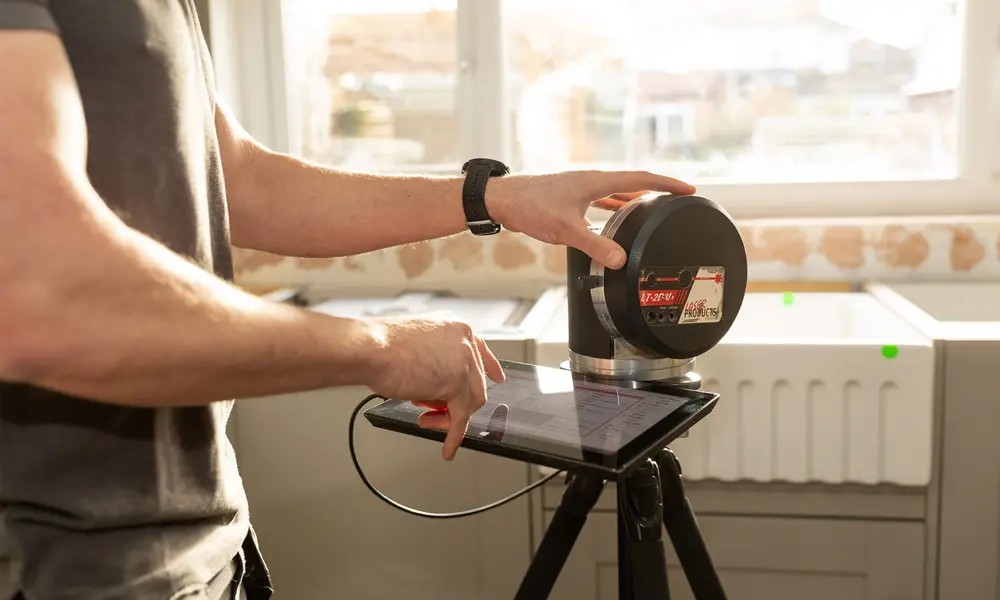 Laser templating being carried out on fitted kitchen units